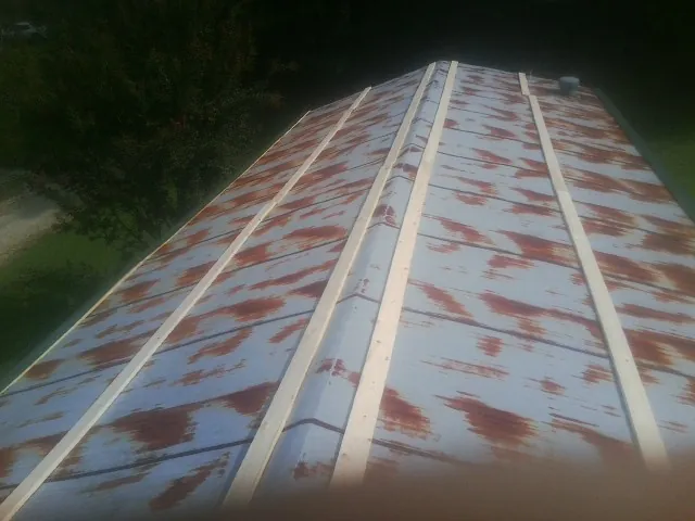 Rusted metal roof panels with new wood purlins before replacement — Storm Damage Roof Repair in Nokomis by Roofing Brothers